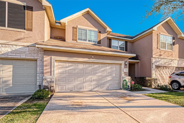 2827 Silver Charm, Houston, TX 77014 - view of property with stone siding, a garage, stucco siding, and concrete driveway