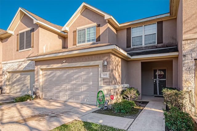 2827 Silver Charm, Houston, TX 77014 - townhome / multi-family property with stone siding, stucco siding, an attached garage, and concrete driveway