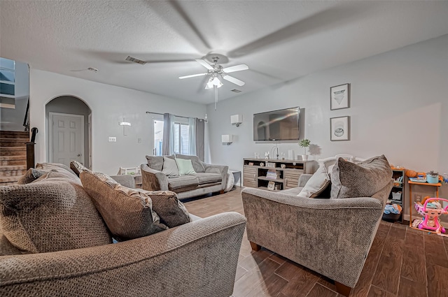 2827 Silver Charm, Houston, TX 77014 - living room featuring ceiling fan, stairs, wood finished floors, and arched walkways
