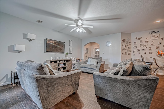 2827 Silver Charm, Houston, TX 77014 - living room with arched walkways, a ceiling fan, wood finished floors, baseboards, and a textured ceiling