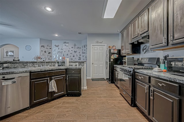 2827 Silver Charm, Houston, TX 77014 - kitchen featuring gas stove, dishwasher, a sink, light wood-type flooring, and arched walkways