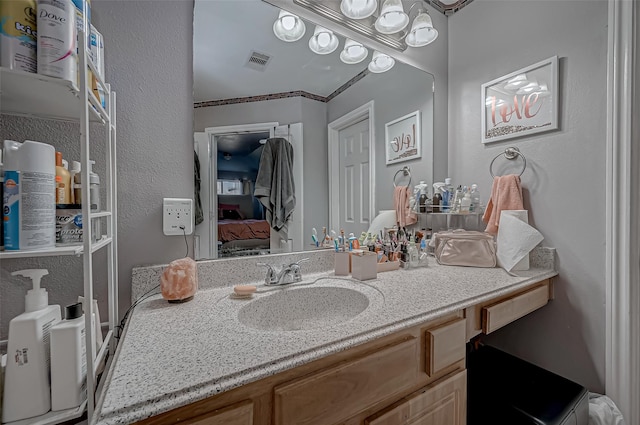 2827 Silver Charm, Houston, TX 77014 - bathroom featuring vanity, a textured wall, connected bathroom, and a chandelier