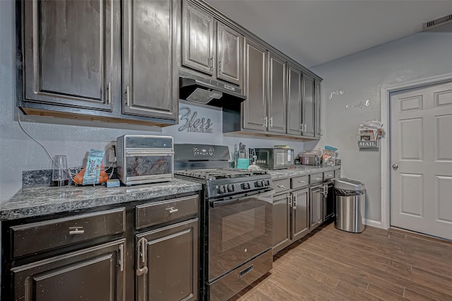 2827 Silver Charm, Houston, TX 77014 - kitchen featuring gas stove, under cabinet range hood, and light wood-style floors