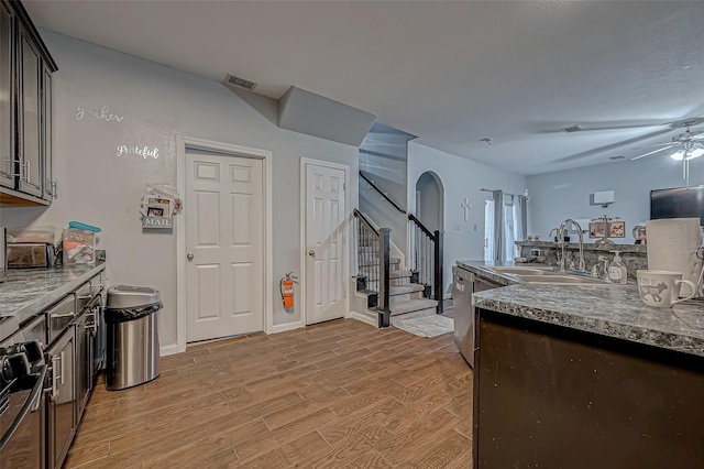 2827 Silver Charm, Houston, TX 77014 - kitchen with a sink, light wood-style floors, a ceiling fan, and arched walkways