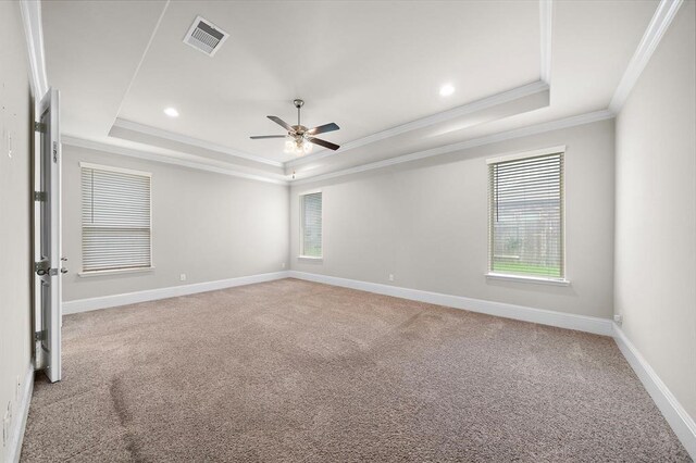 28911 Copper Break Ct, Katy, TX 77494 - empty room featuring a tray ceiling, ornamental molding, a ceiling fan, light carpet, and baseboards