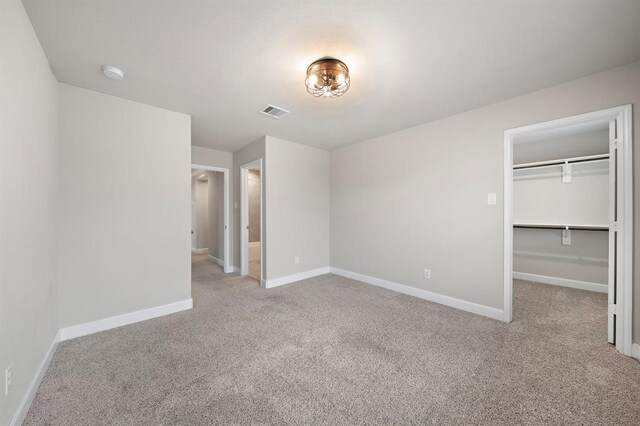 28911 Copper Break Ct, Katy, TX 77494 - unfurnished bedroom with carpet, baseboards, and a walk in closet