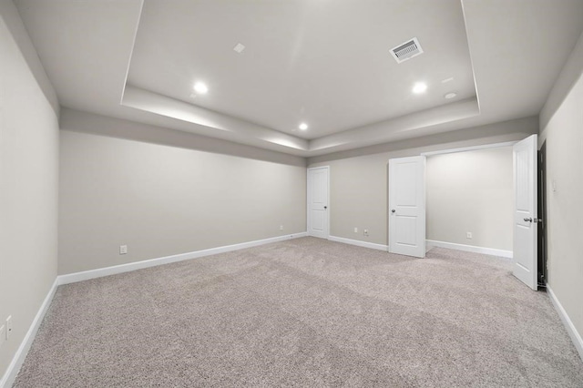 28911 Copper Break Ct, Katy, TX 77494 - spare room featuring a tray ceiling, light colored carpet, recessed lighting, and baseboards