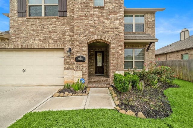 28911 Copper Break Ct, Katy, TX 77494 - view of front of house with brick siding, an attached garage, driveway, and stone siding