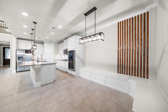 28911 Copper Break Ct, Katy, TX 77494 - kitchen featuring appliances with stainless steel finishes, a sink, recessed lighting, light stone countertops, and white cabinetry