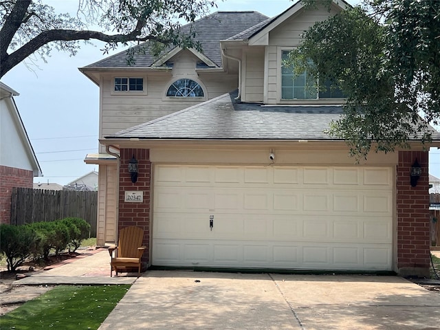 20347 Hunterclif Ln, Katy, TX 77449 - view of front of house with roof with shingles, brick siding, and a garage