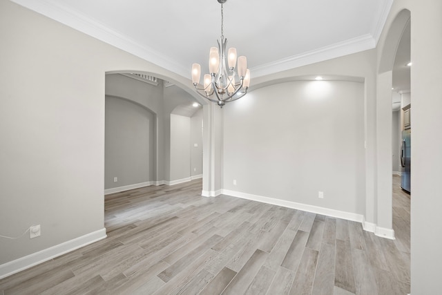 4021 Windsor Chase Dr, Spring, TX 77386 - unfurnished room with arched walkways, ornamental molding, light wood finished floors, a chandelier, and baseboards