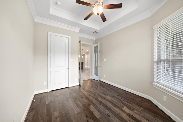 4021 Windsor Chase Dr, Spring, TX 77386 - unfurnished bedroom featuring dark wood-style flooring, ornamental molding, a tray ceiling, and baseboards