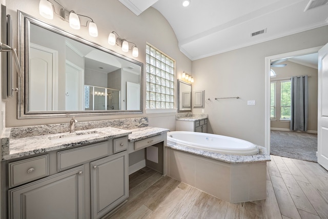 4021 Windsor Chase Dr, Spring, TX 77386 - bathroom with vaulted ceiling, a stall shower, wood finished floors, crown molding, and a garden tub