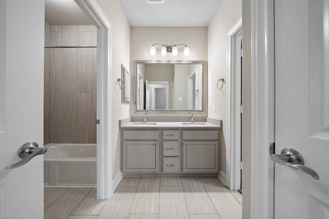 4021 Windsor Chase Dr, Spring, TX 77386 - bathroom featuring double vanity, baseboards, tub / shower combination, and wood finish floors