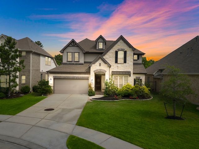 4021 Windsor Chase Dr, Spring, TX 77386 - french country inspired facade featuring stone siding, driveway, an attached garage, a front lawn, and stucco siding
