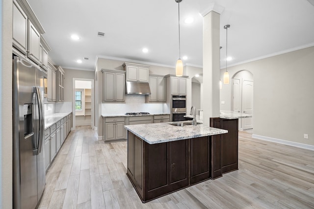 4021 Windsor Chase Dr, Spring, TX 77386 - kitchen featuring appliances with stainless steel finishes, a sink, under cabinet range hood, gray cabinetry, and light wood-style flooring