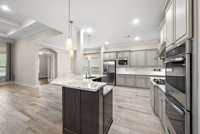 4021 Windsor Chase Dr, Spring, TX 77386 - kitchen with appliances with stainless steel finishes, arched walkways, crown molding, tasteful backsplash, and light wood-style floors