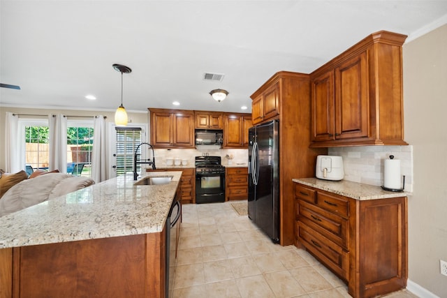 3431 Bristlecone Trl, Spring, TX 77380 - kitchen with black appliances, a sink, tasteful backsplash, brown cabinetry, and light stone counters