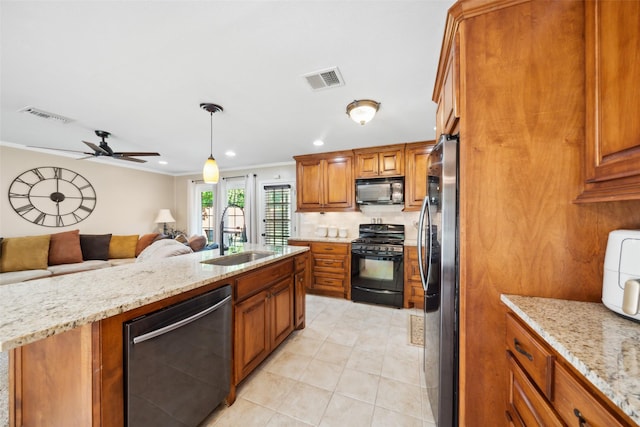 3431 Bristlecone Trl, Spring, TX 77380 - kitchen featuring black appliances, a sink, open floor plan, brown cabinetry, and ceiling fan