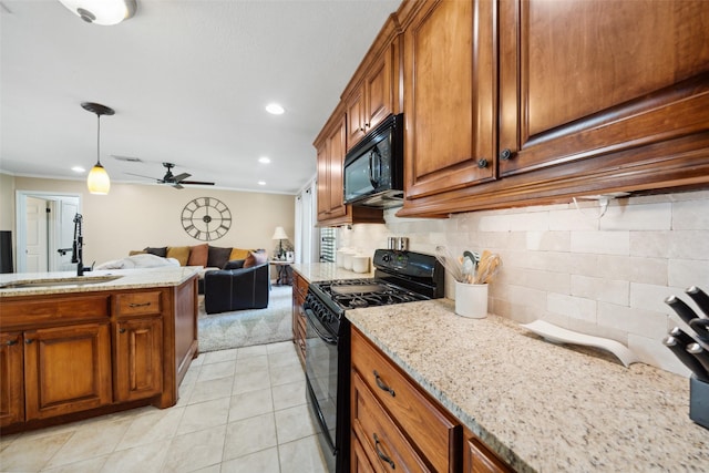 3431 Bristlecone Trl, Spring, TX 77380 - kitchen with black appliances, brown cabinetry, a sink, ceiling fan, and light stone countertops