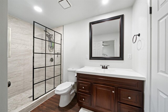 3431 Bristlecone Trl, Spring, TX 77380 - full bath featuring vanity, toilet, wood finished floors, a tile shower, and recessed lighting