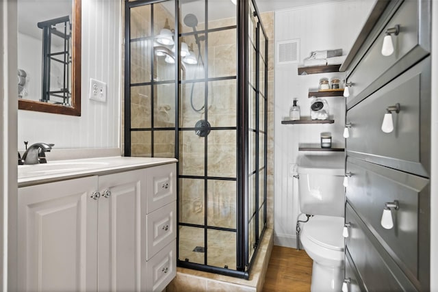 3431 Bristlecone Trl, Spring, TX 77380 - bathroom with toilet, a stall shower, vanity, and wood finished floors