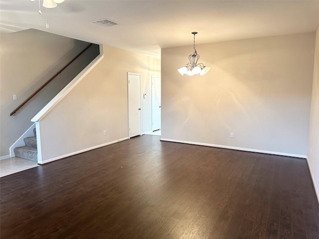 2924 Holly Hall St Unit 2924, Houston, TX 77054 - unfurnished living room featuring stairs, wood finished floors, baseboards, and a chandelier