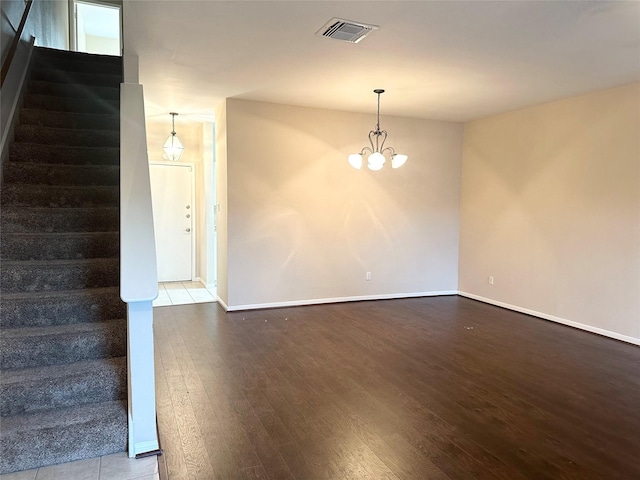 2924 Holly Hall St Unit 2924, Houston, TX 77054 - unfurnished room with stairs, wood finished floors, baseboards, and a chandelier