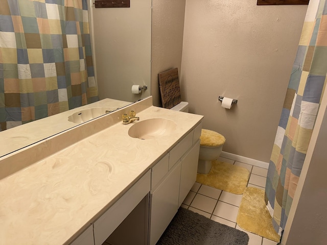 2924 Holly Hall St Unit 2924, Houston, TX 77054 - bathroom featuring toilet, tile patterned floors, vanity, baseboards, and curtained shower