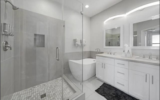 6617 Del Rio St Unit D, Houston, TX 77021 - full bathroom with double vanity, a stall shower, a freestanding tub, and tile patterned floors