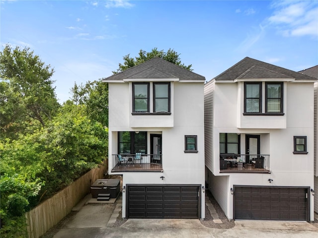 6617 Del Rio St Unit D, Houston, TX 77021 - view of front facade with a garage, stucco siding, and a balcony