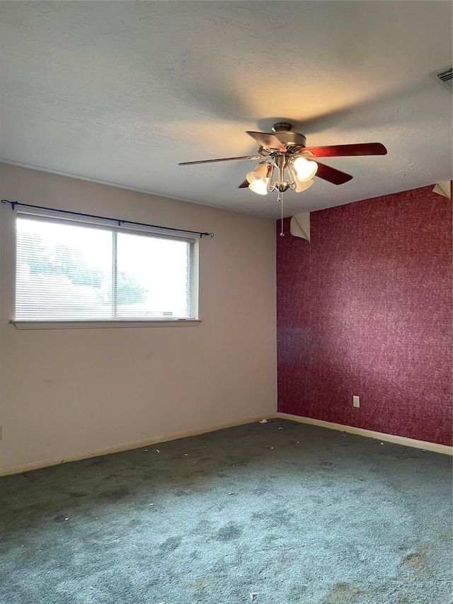 1501 N Park Side Dr, Deer Park, TX 77536 - spare room featuring ceiling fan, carpet, baseboards, a textured ceiling, and wallpapered walls