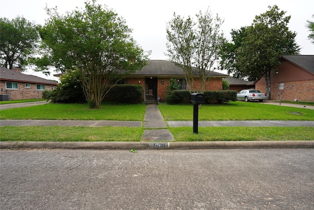 1501 N Park Side Dr, Deer Park, TX 77536 - single story home featuring a front lawn, brick siding, and cooling unit