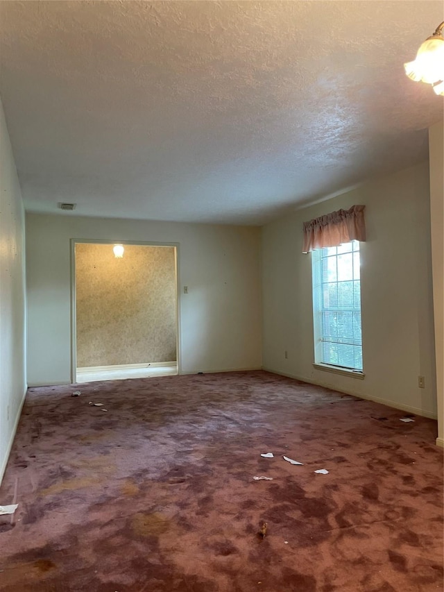 1501 N Park Side Dr, Deer Park, TX 77536 - carpeted spare room with baseboards and a textured ceiling
