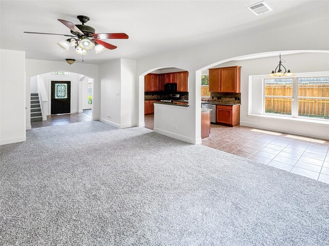 16019 Rustlers Trail Ln, Cypress, TX 77429 - unfurnished living room featuring arched walkways, plenty of natural light, a ceiling fan, and light carpet