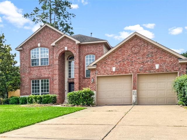 16019 Rustlers Trail Ln, Cypress, TX 77429 - traditional home featuring concrete driveway, an attached garage, brick siding, and a front yard