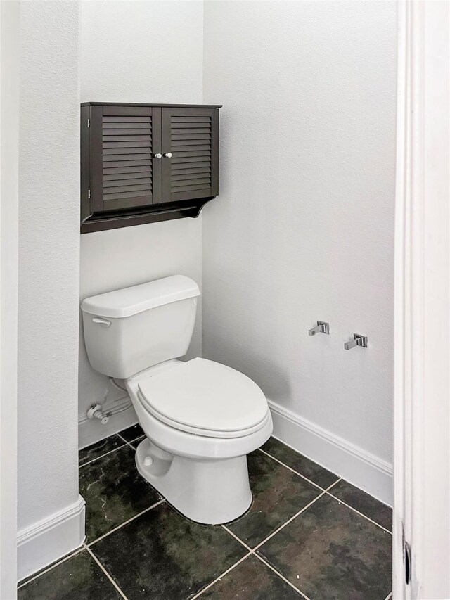 16019 Rustlers Trail Ln, Cypress, TX 77429 - bathroom featuring toilet, tile patterned flooring, and baseboards