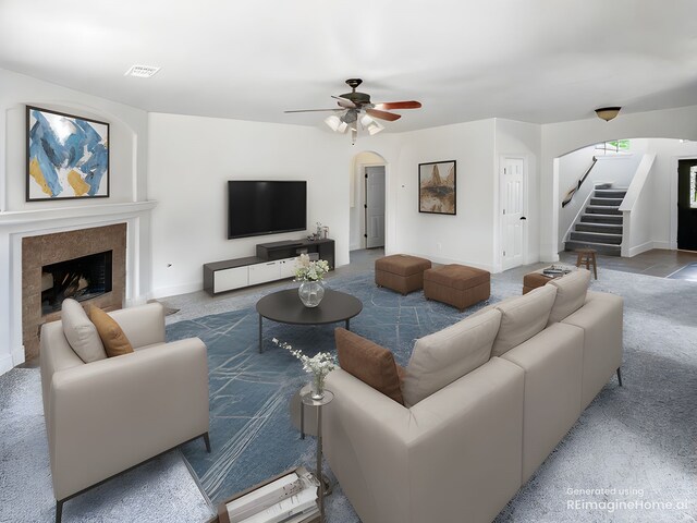 16019 Rustlers Trail Ln, Cypress, TX 77429 - living area featuring stairway, carpet flooring, ceiling fan, arched walkways, and a fireplace