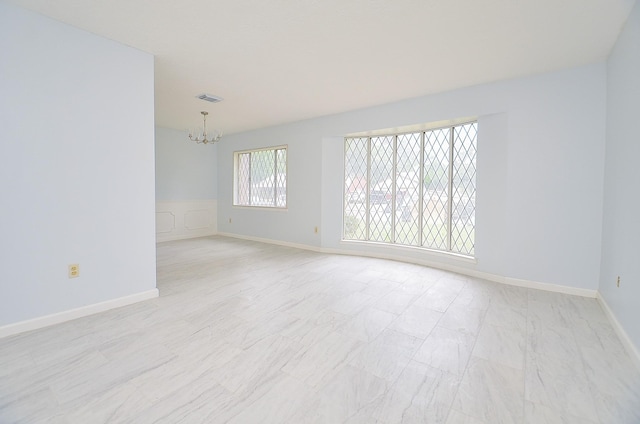 10947 Vanderford Dr, Houston, TX 77099 - spare room featuring a chandelier and baseboards