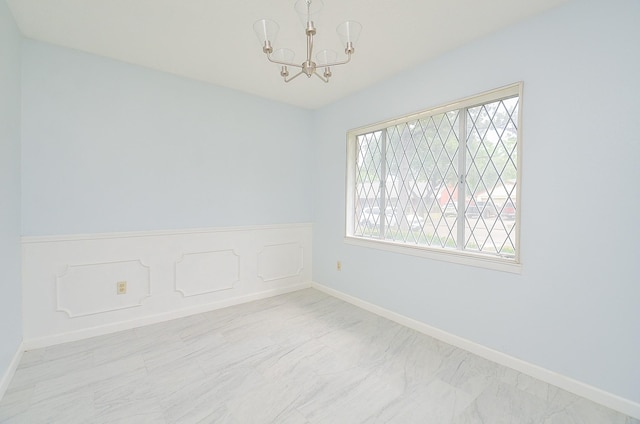 10947 Vanderford Dr, Houston, TX 77099 - empty room featuring a chandelier, marble finish floors, and baseboards