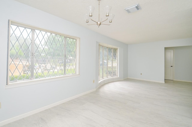 10947 Vanderford Dr, Houston, TX 77099 - empty room featuring a chandelier and baseboards