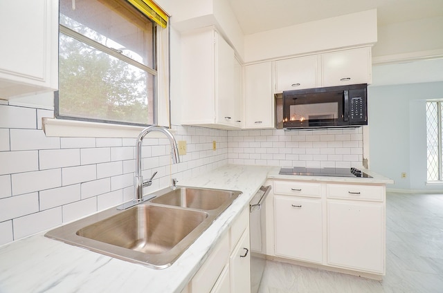 10947 Vanderford Dr, Houston, TX 77099 - kitchen featuring black appliances, a sink, white cabinetry, and tasteful backsplash