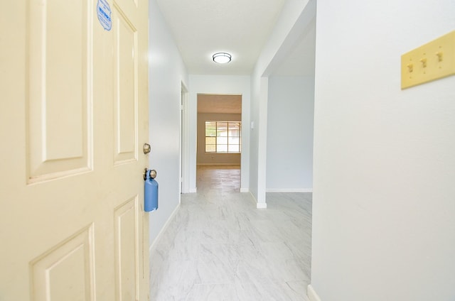 10947 Vanderford Dr, Houston, TX 77099 - hallway with light marble finish floors and baseboards