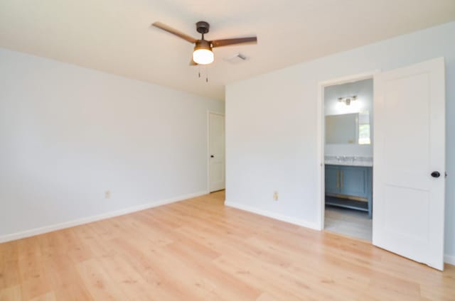 10947 Vanderford Dr, Houston, TX 77099 - unfurnished bedroom featuring light wood finished floors, baseboards, ensuite bathroom, and a ceiling fan