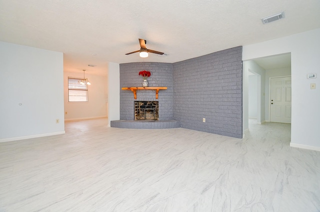 10947 Vanderford Dr, Houston, TX 77099 - unfurnished living room featuring ceiling fan, a brick fireplace, baseboards, brick wall, and a textured ceiling