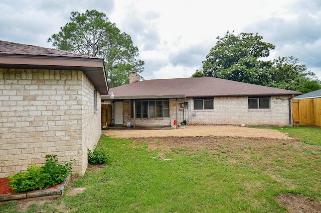 10947 Vanderford Dr, Houston, TX 77099 - rear view of property with a chimney, brick siding, and a shingled roof