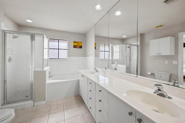 939 Colorado St Unit 22, Houston, TX 77007 - full bathroom featuring toilet, a garden tub, a shower stall, double vanity, and healthy amount of natural light