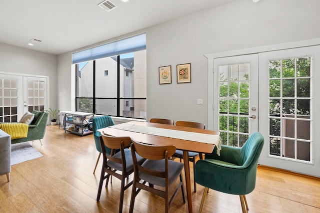 939 Colorado St Unit 22, Houston, TX 77007 - dining area featuring french doors, plenty of natural light, light wood-style flooring, and recessed lighting