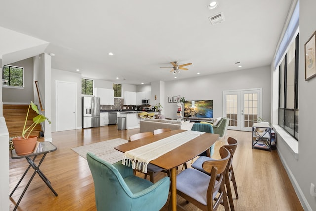 939 Colorado St Unit 22, Houston, TX 77007 - dining room featuring ceiling fan, recessed lighting, light wood-type flooring, stairway, and french doors