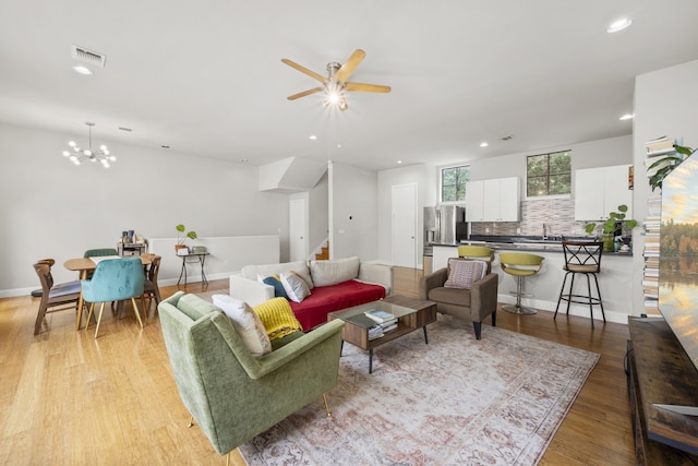 939 Colorado St Unit 22, Houston, TX 77007 - living room featuring ceiling fan, recessed lighting, wood finished floors, stairway, and a chandelier